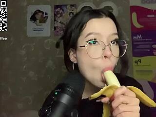 Small-breasted girl gives a handjob to a big banana in ASMR