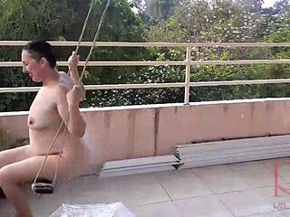 A housewife indulges in swinging without underwear while seeking shelter from rain under an umbrella in a classic full-length video