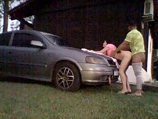 Amateur couple tries out shock absorbers on car's hood
